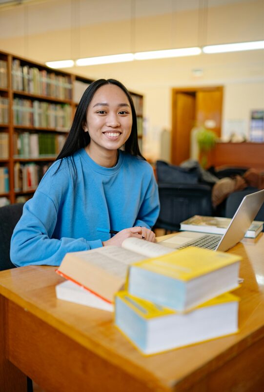 Language Learner with Books and Laptop